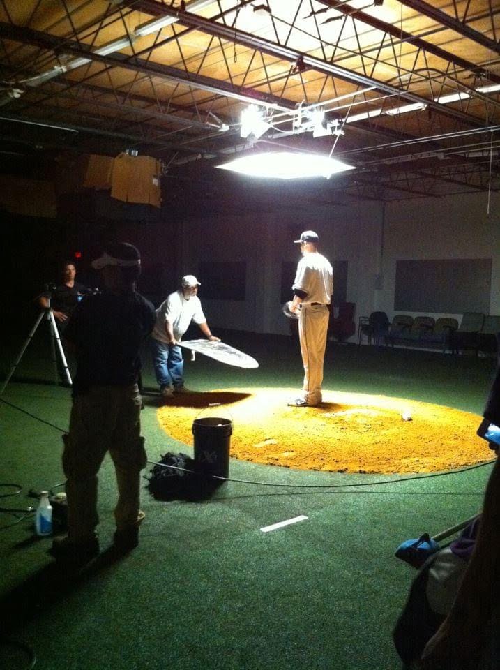 Baseball pitcher standing on a mound in a studio for a commercial